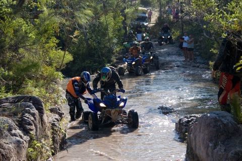 Quad bikes up a creek bed